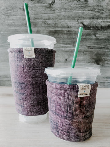 Purple & Black Sketch Iced Drink Snug. Tired of sweating iced drink cups?  Or ice just melting too fast in your cold drink?   Insulate your cup with a modern, stylish cup snug.  Keep your coffee cold, hands warm and water rings off the table.  It may also be used on hot cups.
