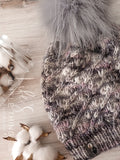 Live. Love. Stay Cozy. Out on the town or on a neighborhood stroll, you will stay warm all fall and winter in this handmade, modern beanie with a medium snap on pom-pom to add a little flair.