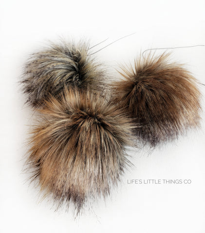 Falcon pom pom Grey and brown in center. Tips are tan, beige, or mustard, with black.  No two poms are alike! *Medium length fur (approximately 2-2.5") *Luxurious and amazingly soft feel 