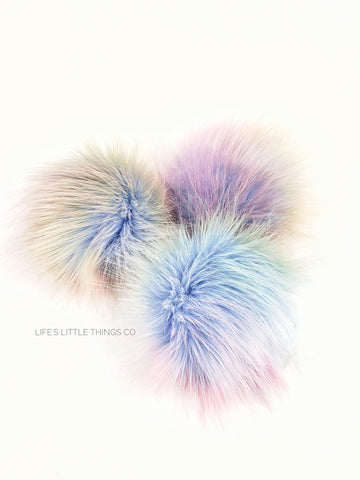 Opal Pom Light blue in center to muted rainbow colors. NO TWO poms are alike! Medium length fur (approximately 2" - 2.5") Luxurious and amazingly soft feel