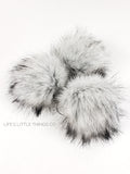 Thunder Fox Pom Grey center to a light grey/white with black tips.  Short length fur (approximately 1.5" - 2") Luxurious and amazingly soft feel