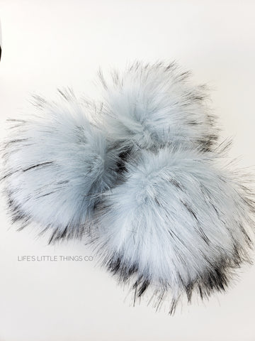 Reflection Faux Fur Pom Pale blue with tufts of of same color with black tips Long length fur (approximately 2.5" - 3") Very full pom Luxurious and amazingly soft feel