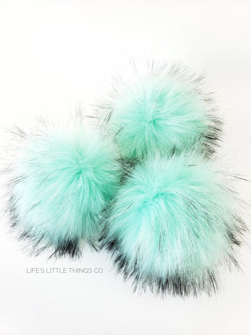 Spearmint Faux Fur Pom A sea foam green with tufts of of same color with black tips Long length fur (approximately 2.5" - 3") Very full pom Luxurious and amazingly soft feel