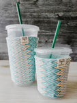 Teal & Yellow Zig-Zag Iced Drink Snug. Tired of sweating iced drink cups?  Or ice just melting too fast in your cold drink?   Insulate your cup with a modern, stylish cup snug.  Keep your coffee cold, hands warm and water rings off the table.  It may also be used on hot cups.