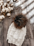 Live. Love. Stay Cozy. Out on the town or on a neighborhood stroll, you will stay warm all fall and winter in this handmade, modern beanie with a large snap on pom-pom to add a little flair.  Merino wool in white.  Topped with a HANDMADE snap on faux fur pom-pom in a black with rust tips. 