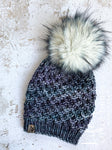 Live. Love. Stay Cozy. Out on the town or on a neighborhood stroll, you will stay warm all fall and winter in this handmade, modern beanie with a medium snap on pom-pom to add a little flair.