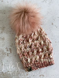 Hand dyed Merino wool in cream, blush and grey.  Topped with a HANDMADE snap on faux fur pom-pom in a dusty blush. 
