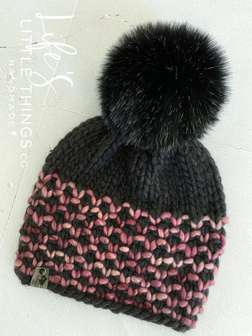 Merino wool in dark heather grey and mauve tones.  Topped with a HANDMADE snap on faux fur pom-pom in black with specks of white. Thick weight beanie.